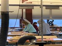 Students working on production machines