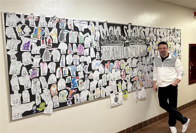  Daniel Jude Miller with student artworks